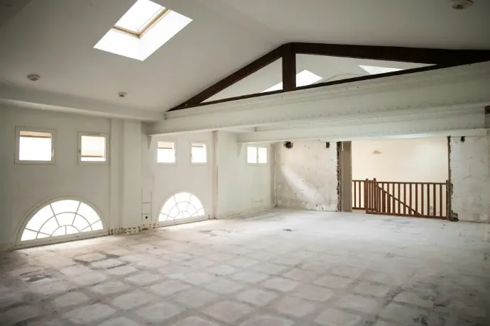 an empty room with a skylight in it